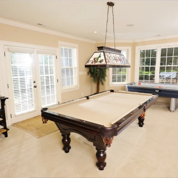GettyImages-1295735468-1 A pool table in the middle of a room.