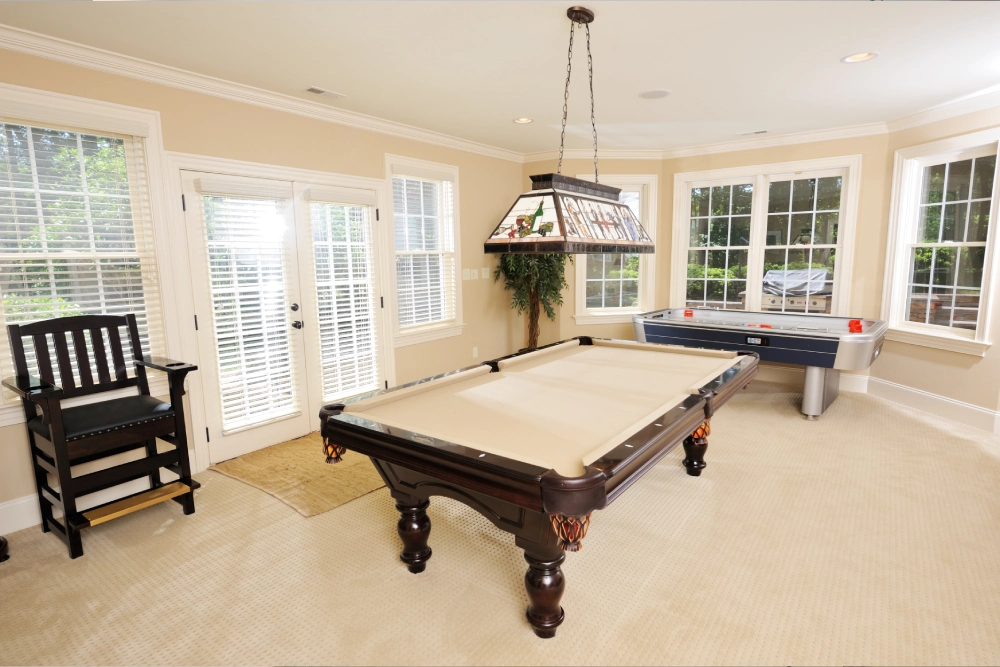 A pool table in the middle of a room.